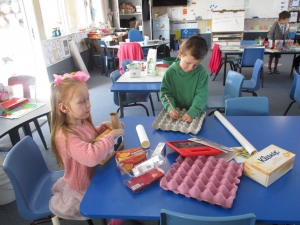 Making a Stegosaurus from cardboard so they can see if the potions work.